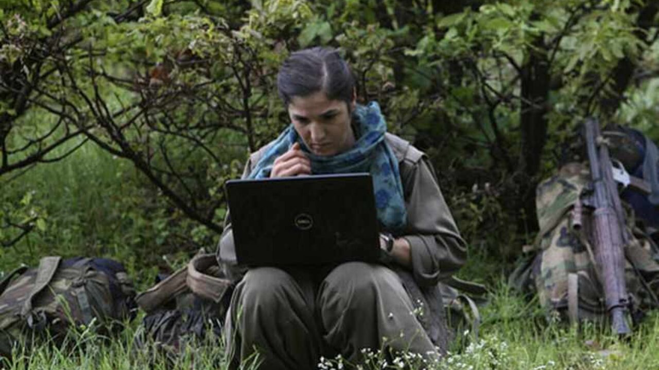 TURKEY-KURDS/IRAQ A member of Kurdistan Workers Party (PKK) works on her laptop in northern Iraq May 14, 2013. The first group of Kurdish militants to withdraw from Turkey under a peace process entered northern Iraq on Tuesday, and were greeted by comrades from the Kurdistan Workers Party (PKK), in a symbolic step towards ending a three-decades-old insurgency. The 13 men and women, carrying guns and with rucksacks on their backs, arrived in the area of Heror, near Metina mountain on the Turkish-Iraqi border, a Reuters witnes
