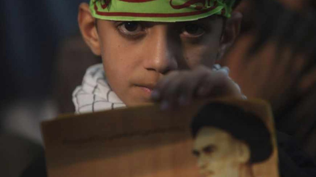 Youth holds picture of Iran's late leader Ayatollah Ruhollah Khomeini during a ceremony to mark Khomeini's death anniversary at his tomb in Tehran A youth holds a picture of Iran's late leader Ayatollah Ruhollah Khomeini during a ceremony to mark Khomeini's death anniversary at his tomb at Tehran's Behesht-Zahra cemetery June 3, 2011. REUTERS/Morteza Nikoubazl (IRAN - Tags: POLITICS ANNIVERSARY RELIGION) - RTR2N9KQ
