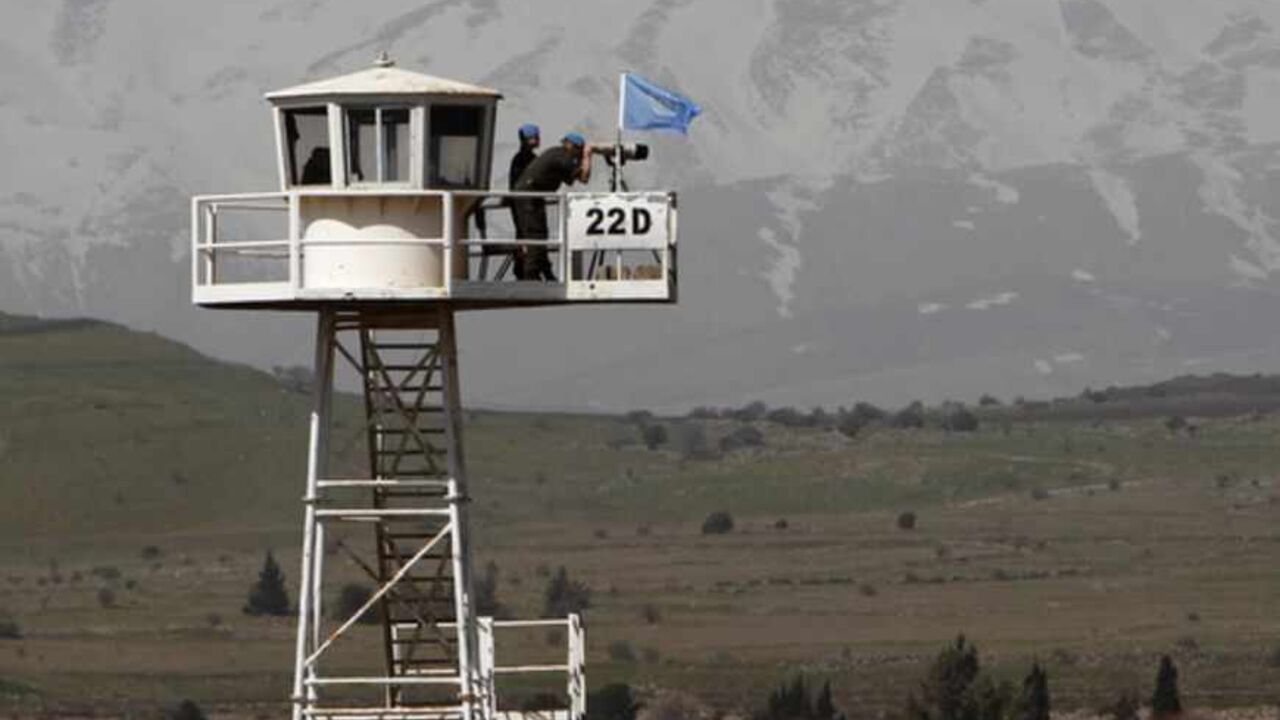 UNDOF Soldiers stand on an observation tower overlooking Syria and located on the Israeli side of the 1973 Golan Heights ceasefire line Soldiers of the U.N. Disengagement Observer Force (UNDOF), stand on an observation tower overlooking Syria and located on the Israeli side of the 1973 Golan Heights ceasefire line with Syria March 21, 2012. Blue-helmeted United Nations peacekeeping troops patrolling a slice of Syrian territory to maintain a ceasefire with Israel face new risks as violence between Syrian government loyalists and rebels gets closer. Picture taken March 21, 2012. REUTERS/Ronen Zvulun (POLITICS MILITARY CONFLICT) - RTR2ZRIQ