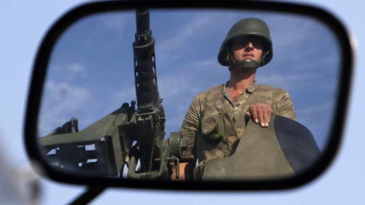 A Turkish soldier is reflected on a mirror as he stands guard on top of an armoured personnel carrier on the Turkish-Syrian border near the Akcakale border crossing A Turkish soldier is reflected on a mirror as he stands guard on top of an armoured personnel carrier on the Turkish-Syrian border near the Akcakale border crossing, southern Sanliurfa province, October 4, 2012. Turkey's parliament gave authorisation on Thursday for military operations outside Turkish borders if the government deemed them necessary, a day after artillery shelling from Syria killed five civilians in the Turkish town of Akcakale. REUTERS/Murad Sezer (TURKEY - Tags: POLITICS CONFLICT MILITARY)