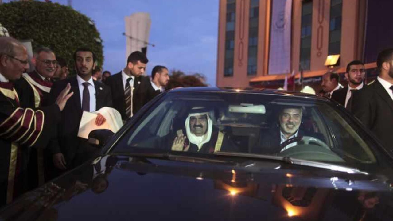Hamas Prime Minister Haniyeh drives a car as the Emir of Qatar sits next to him in Gaza City Hamas Prime Minister Ismail Haniyeh drives a car as the Emir of Qatar Sheikh Hamad bin Khalifa al-Thani sits next to him after a visit at the Islamic University in Gaza City October 23, 2012. The Emir of Qatar embraced the Hamas leadership of Gaza on Tuesday with an official visit that broke the isolation of the Palestinian Islamist movement, to the dismay of Israel and rival, Western-backed Palestinian leaders. REUTERS/Wissam Nassar/Pool (GAZA - Tags: POLITICS) - RTR39HDC
