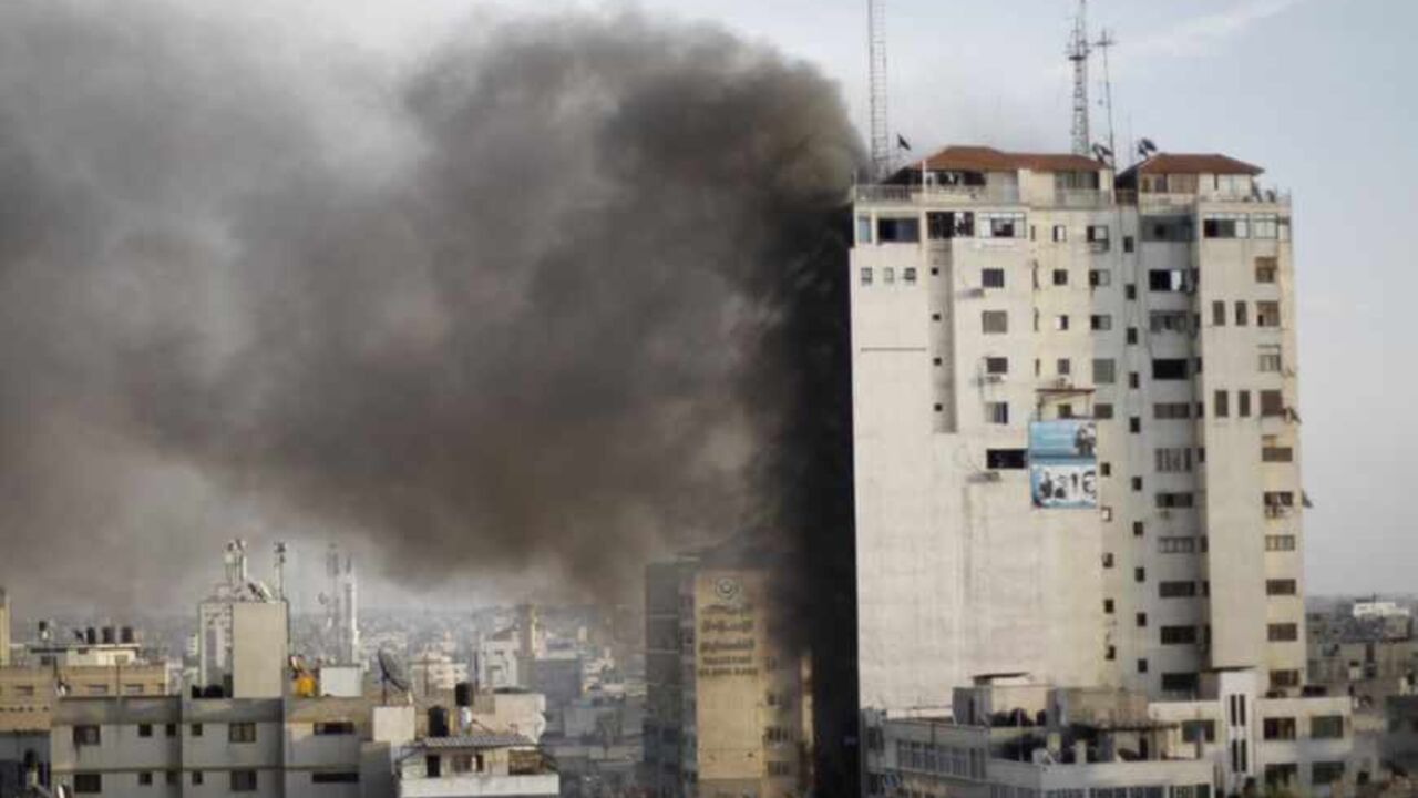 Smoke is seen after an after an Israeli air strike, witnessed by a Reuters journalist, out of a floor in a building that also houses media offices in Gaza City Smoke is seen after an after an Israeli air strike, witnessed by a Reuters journalist, out of a floor in a building that also houses media offices in Gaza City November 19, 2012. An Islamic Jihad local commander was killed on Monday in an Israeli air strike on a tower block that houses many international media, a source in the militant group said. REUTERS/Ahmed Jadallah (GAZA - Tags: MILITARY CONFLICT MEDIA) - RTR3AM74