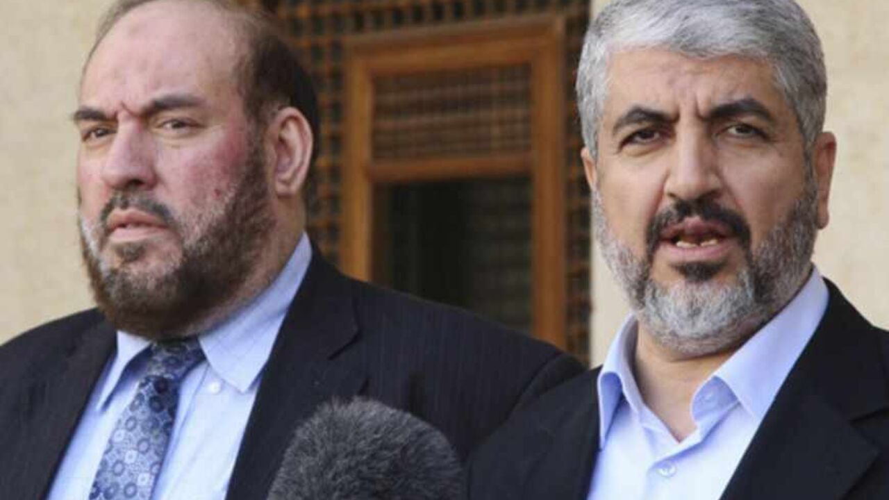 Hamas leader Meshaal and Nazzal, a member of the Hamas leadership, speak to media after their meeting with Jordan's King Abdullah in Amman Hamas leader Khaled Meshaal (R) and Mohammad Nazzal, a member of the Hamas leadership, speak to media after their meeting with Jordan's King Abdullah at the Royal Palace in Amman January 28, 2013. REUTERS/Majed Jaber (JORDAN - Tags: POLITICS) - RTR3D30A