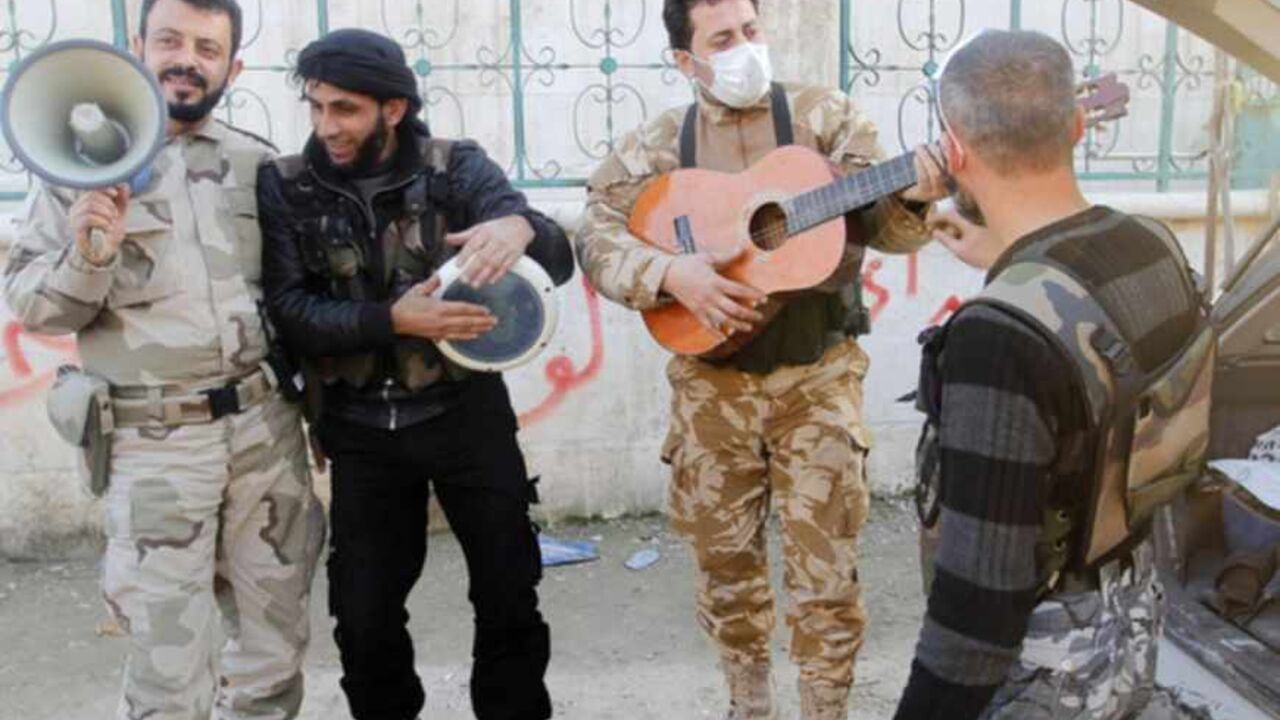 Members of the Free Syrian Army chant as one of them plays the guitar near Nairab military airport in Aleppo Members of the Free Syrian Army chant as one of them plays the guitar near Nairab military airport in Aleppo February 26, 2013. REUTERS/Hamid Khatib (SYRIA - Tags: CONFLICT POLITICS) - RTR3EBGO