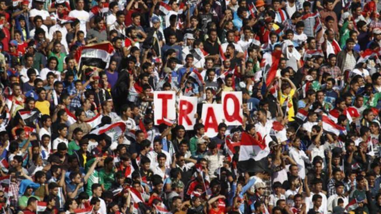 Iraq's fans hold up placards during the team's international friendly soccer match against Syria in Baghdad Iraq's fans hold up placards during the team's international friendly soccer match against Syria at Baghdad's Shaab stadium March 26, 2013. Iraq will be allowed to play friendly matches at home again following approval from soccer's world governing body FIFA on Thursday. Iraq were banned from playing all games at home for security reasons after losing a World Cup qualifier 2-0 to Jordan at the Franso Hariri Stadium in Arbil in September 2011. The reprieve does not apply to World Cup qualifiers for which Ira