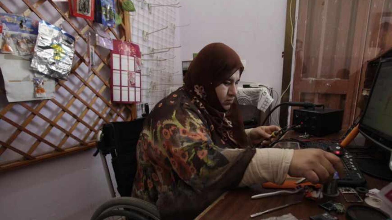 A wheelchair-bound Palestinian woman Manal al-Satari, 37, fixes cell phones at her shop in Rafah in the southern Gaza Strip A wheelchair-bound Palestinian woman Manal al-Satari, 37, fixes cell phones at her shop in Rafah in the southern Gaza Strip April 7, 2013.
REUTERS/Ibraheem Abu Mustafa (GAZA - Tags: SOCIETY) - RTXYBPS