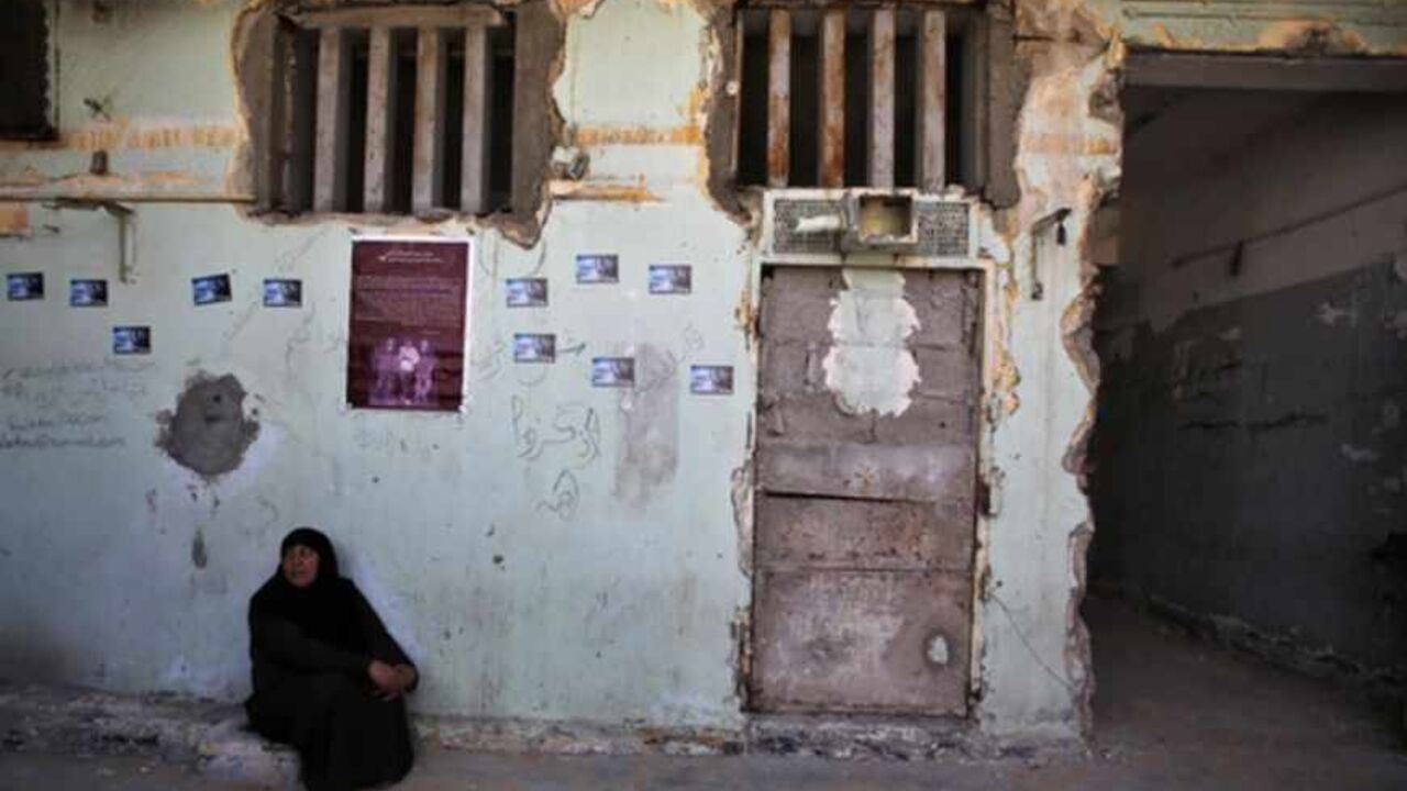 A Palestinian woman sits at Saraya prison that had been used by Israeli security services to keep Palestinian prisoners during Israel's occupation of Gaza Strip A Palestinian woman sits at Saraya prison that had been used by Israeli security services to keep Palestinian prisoners during Israel's occupation of Gaza Strip April 14, 2013. Murals of famous leaders of Palestinian militant groups who were once held in the prison decorated walls at the site, along with a leather banner listing the names of 12 detainees who died in what locals dubbed "the slaughterhouse". Picture taken April 14, 2013. REUTERS/Suhaib Salem (GAZA - Tags: POLITICS CIVIL UNREST) - RTXYNPC