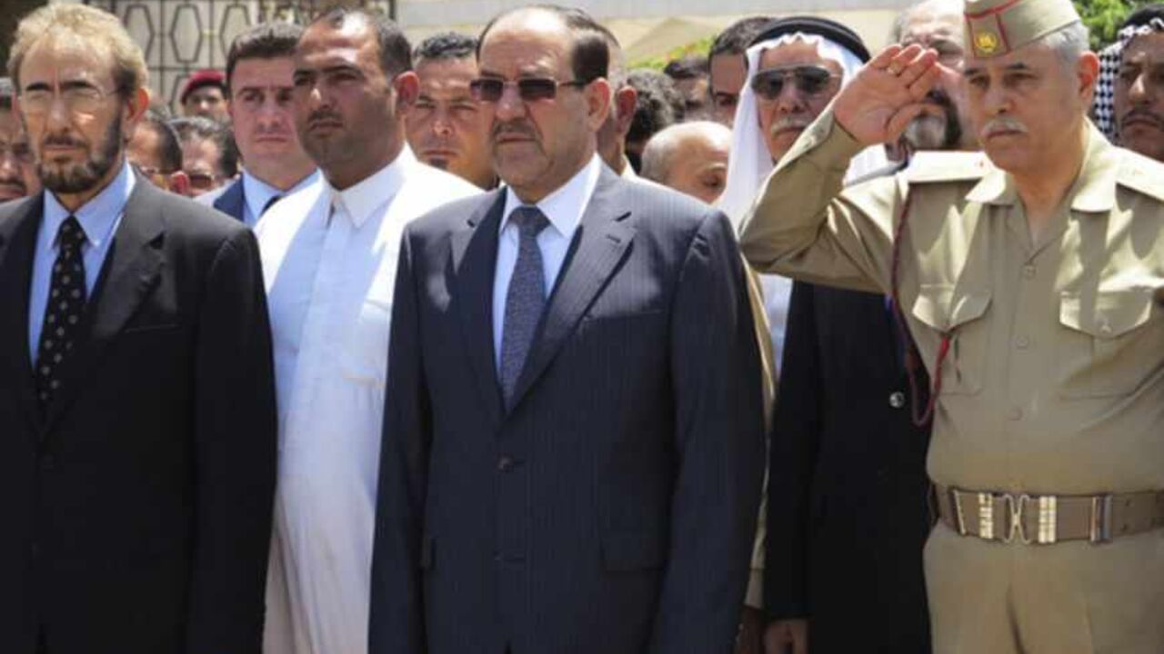 Iraq's PM al-Maliki and acting Defence Minister al-Dulaimi attend a funeral ceremony for soldiers killed by militants, in Baghdad Iraq's Prime Minister Nuri al-Maliki (C) and acting Defence Minister Saadoun al-Dulaimi (L) attend a funeral ceremony for soldiers killed by militants, in Baghdad April 28, 2013. Militants shot dead five Iraqi soldiers in the Sunni Muslim stronghold province of Anbar on Saturday and protesters said they were forming an "army" after four days of unrest that raised fears of a return to widespread sectarian civil conflict. REUTERS/Stringer (IRAQ - Tags: POLITICS MILITARY CIVIL UNREST) - RTXZ2Y6