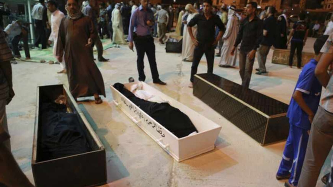 Mourners stand beside coffins of four members of a family killed in Basra bomb attacks, during a funeral in Najaf ATTENTION EDITORS - VISUAL COVERAGE OF SCENES OF INJURY OR DEATH
Mourners stand beside coffins of four members of a family killed in Basra bomb attacks, during a funeral in Najaf, around 160 km (99 miles) south of Baghdad May 20, 2013. More than 70 people were killed in a series of car bombings and suicide attacks targeting Shi'ite Muslims across Iraq on Monday, police and medics said, extending the worst sectarian violence since U.S. troops withdrew in December 2011. The attacks increased the number kil