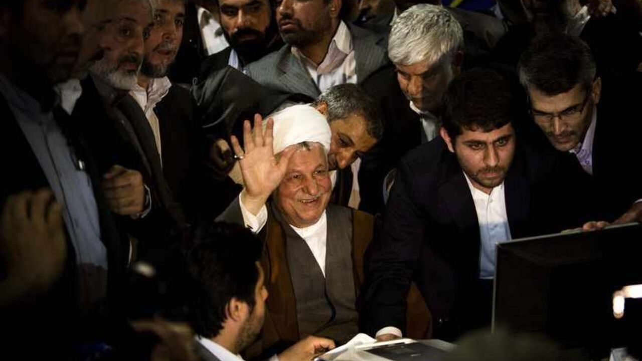 Former Iranian president Akbar Hashemi Rafsanjani (C) waves as he registers his candidacy for the upcoming presidential election at the interior ministry in Tehran on May 11, 2013. Rafsanjani, who has been isolated since the 2009 presidential election which saw massive street protests against the disputed re-election of President Mahmoud Ahmadinejad, registered his candidacy to stand for office again. AFP PHOTO/BEHROUZ MEHRI        (Photo credit should read BEHROUZ MEHRI/AFP/Getty Images)