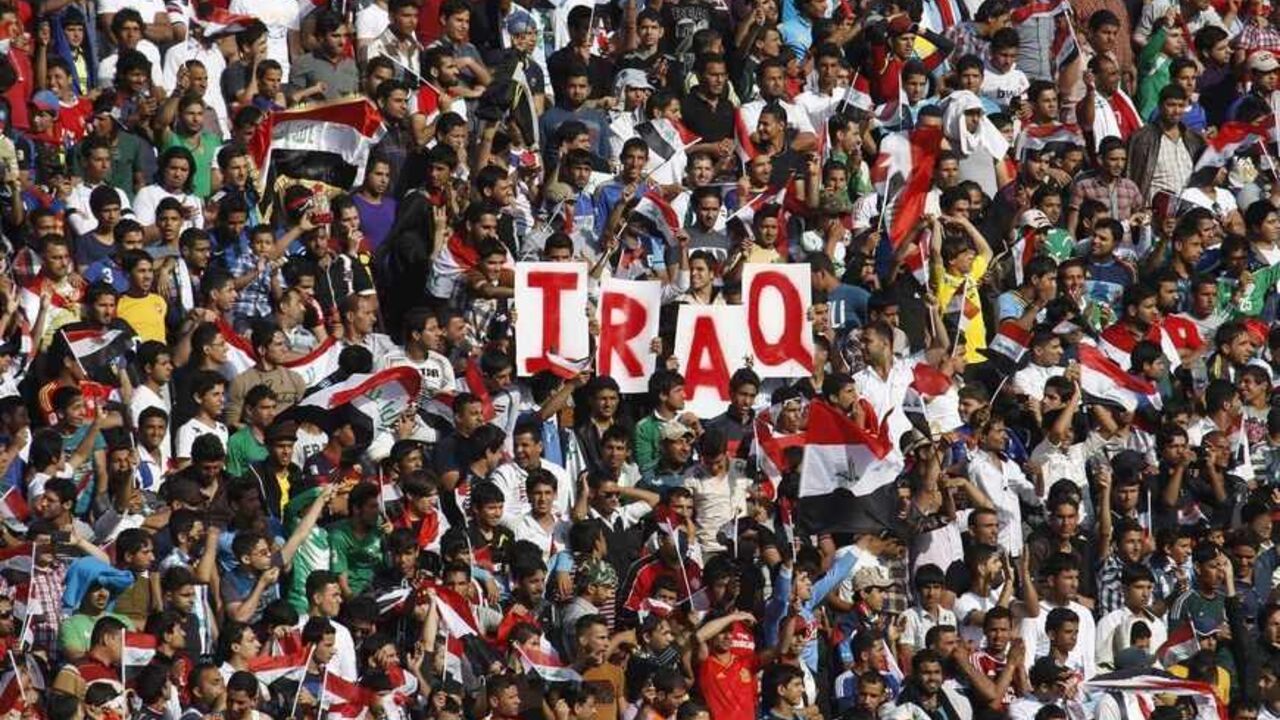 SOCCER-FRIENDLY/ Iraq's fans hold up placards during the team's international friendly soccer match against Syria at Baghdad's Shaab stadium March 26, 2013. Iraq will be allowed to play friendly matches at home again following approval from soccer's world governing body FIFA on Thursday. Iraq were banned from playing all games at home for security reasons after losing a World Cup qualifier 2-0 to Jordan at the Franso Hariri Stadium in Arbil in September 2011. The reprieve does not apply to World Cup qualifiers for which Ira