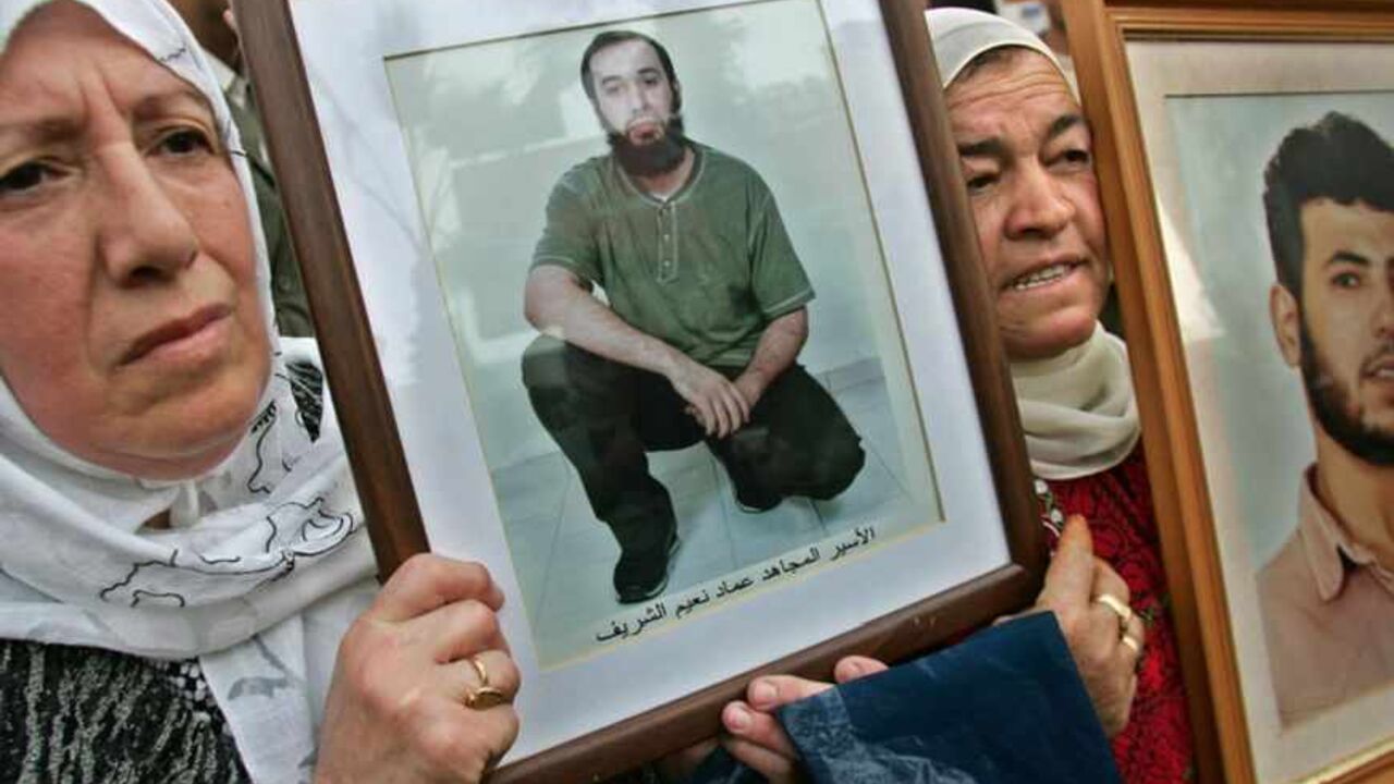 Palestinian women hold pictures of their sons during protest calling for release of Palestinian prisoners in Ramallah Palestinian women hold pictures of their sons during a protest calling for the release of Palestinian prisoners inside Israeli jails, in the West Bank city of Ramallah December 3, 2005. Candidates began signing up on Saturday for a Palestinian legislative election next month at which the ruling Fatah of President Mahmoud Abbas will face its first major challenge from powerful Islamist faction Hamas. REUTERS/Loay Abu Haykel - RTR1A0J5