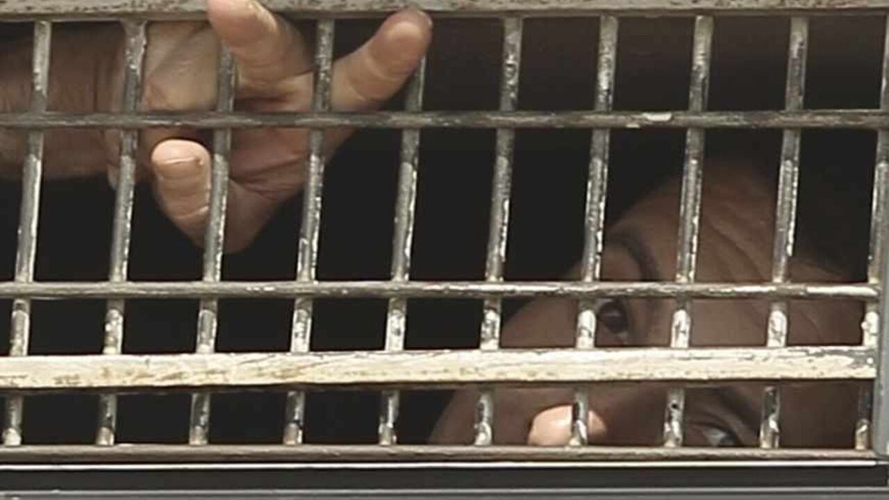 A Palestinian prisoner gestures from the window of a bus as it leaves Nafha Prison in Mitzpe Ramon A Palestinian prisoner gestures from the window of a bus as it leaves Nafha Prison in the southern town of Mitzpe Ramon October 16, 2011, before a prisoner swap that is expected to take place on Tuesday. Israel took the first steps on Sunday in the prisoner swap with Hamas in which hundreds of Palestinian militants will be exchanged for captive Israeli soldier Gilad Shalit. REUTERS/Ilan Assayag (ISRAEL - Tags: POLITICS CIVIL UNREST TPX IMAGES OF THE DAY) ISRAEL OUT. NO COMMERCIAL OR EDITORIAL SALES IN ISRAE