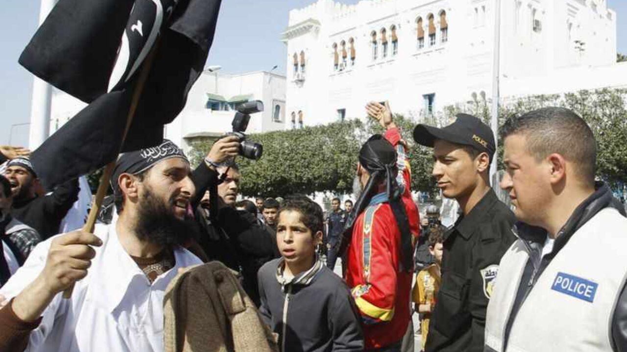 Salafist protester gestures to riot police during protest demanding for inclusion of Islamic Law in constitution in Tunis A salafist protester (L) gestures to riot police during a protest demanding for the inclusion of Islamic Law in the constitution in Tunis March 23, 2012. REUTERS/Zoubeir Souissi (TUNISIA - Tags: POLITICS RELIGION CIVIL UNREST) - RTR2ZRUE