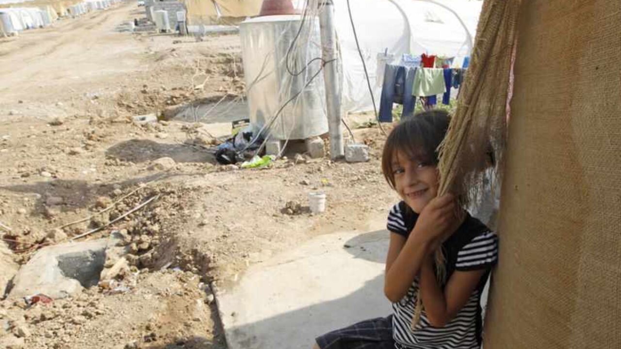 A Syrian refugee, who fled the violence in Syria, is seen at the Domiz refugee camp in the northern Iraqi of province Dohuk A Syrian refugee, who fled the violence in Syria, is seen at the Domiz refugee camp in the northern Iraqi of province Dohuk July 25, 2012. The number of refugees that have fled to Iraq's Kurdistan region is in excess of 11,000 refugees, and they are settled in the region's three provinces: Arbil, Dohuk and Sulaimaniya. As for the Domiz refugee camp, the number of refugee families reached 696 families, equivalent to 2,800 people, but on the other side of the camp, where young refugees are, the number of refu