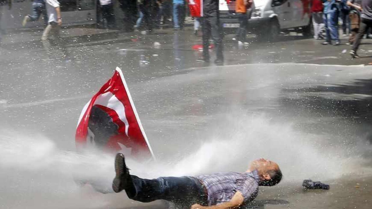 Man is hit by a jet of water as riot police use a water cannon to disperse demonstrators during a protest against Turkey's PM Erdogan and his ruling AKP in central Ankara A man is hit by a jet of water as riot police use a water cannon to disperse demonstrators during a protest against Turkey's Prime Minister Tayyip Erdogan and his ruling Justice and Development Party (AKP) in central Ankara June 1, 2013. Erdogan made a defiant call for an end to the fiercest anti-government demonstrations in years on Saturday, as thousands of protesters clashed with riot police in Istanbul and Ankara for a second day. REUTERS/Umit Bektas (TURKEY - Tags: POLITICS CIVIL UNREST TPX IMAGES
