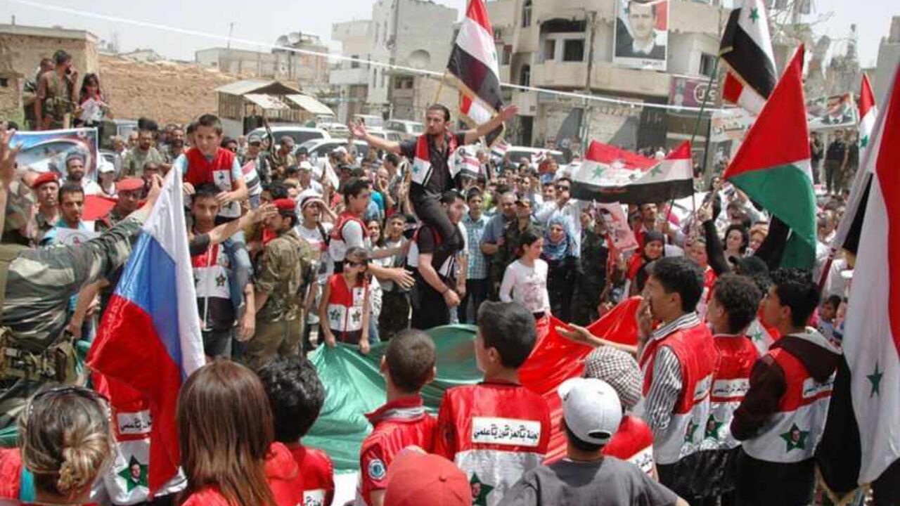 Lebanese and Syrian supporters of Syria's President Bashar al-Assad, celebrate in Qusair June 9, 2013, after the Syrian army and Lebanese Hezbollah fighters took control of the town from rebel fighters in this handout photograph released by Syria's national news agency SANA. REUTERS/SANA/Handout via Reuters (SYRIA - Tags: POLITICS CIVIL UNREST) ATTENTION EDITORS - THIS IMAGE WAS PROVIDED BY A THIRD PARTY. FOR EDITORIAL USE ONLY. NOT FOR SALE FOR MARKETING OR ADVERTISING CAMPAIGNS. THIS PICTURE IS DISTRIBUTE