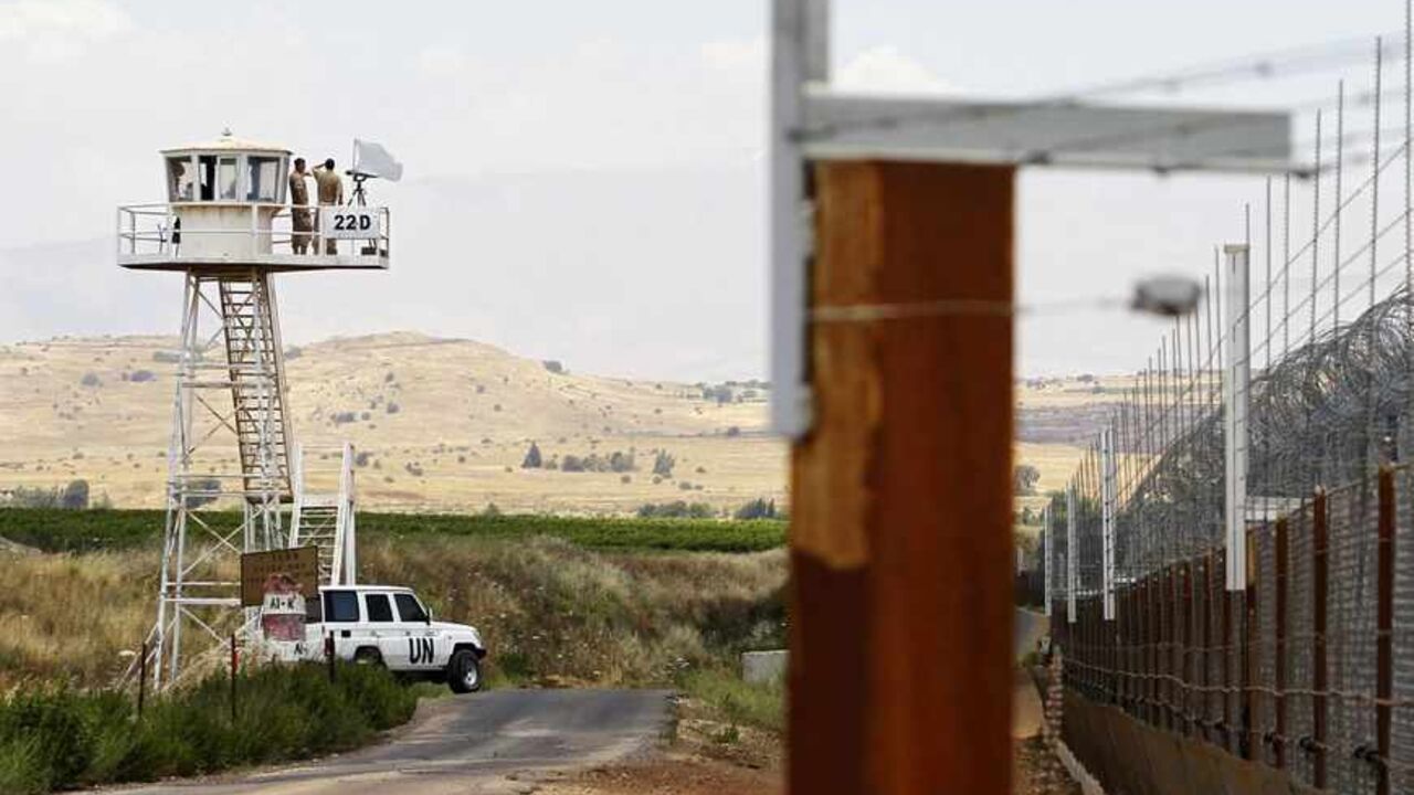 U.N. peacekeeping soldiers from Austria stand on an observation tower near the Quneitra border crossing between Israel and Syria, in the Israeli-occupied Golan Heights United Nations (U.N.) peacekeeping soldiers from Austria stand on an observation tower near the Quneitra border crossing between Israel and Syria, in the Israeli-occupied Golan Heights June 10, 2013. Syrian President Bashar al-Assad, backed by Iran and Lebanon's Hezbollah, may prevail in the more than two-year-old uprising against him, Israel's intelligence minister said on Monday. REUTERS/Baz Ratner (POLITICS) - RTX10ISS