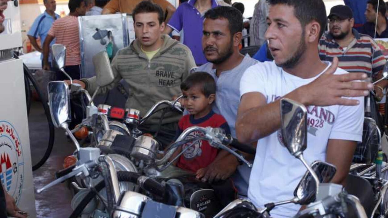 Palestinians wait to fill their motorcycles with fuel at a petrol station in Khan Younis Palestinians wait to fill their motorcycles with fuel at a petrol station in Khan Younis, in the southern Gaza Strip, June 16, 2013. The Gaza Strip is experiencing a shortage in fuel which is smuggled from Egypt to Gaza, residents said. REUTERS/Ibraheem Abu Mustafa (GAZA - Tags: SOCIETY) - RTX10PO7