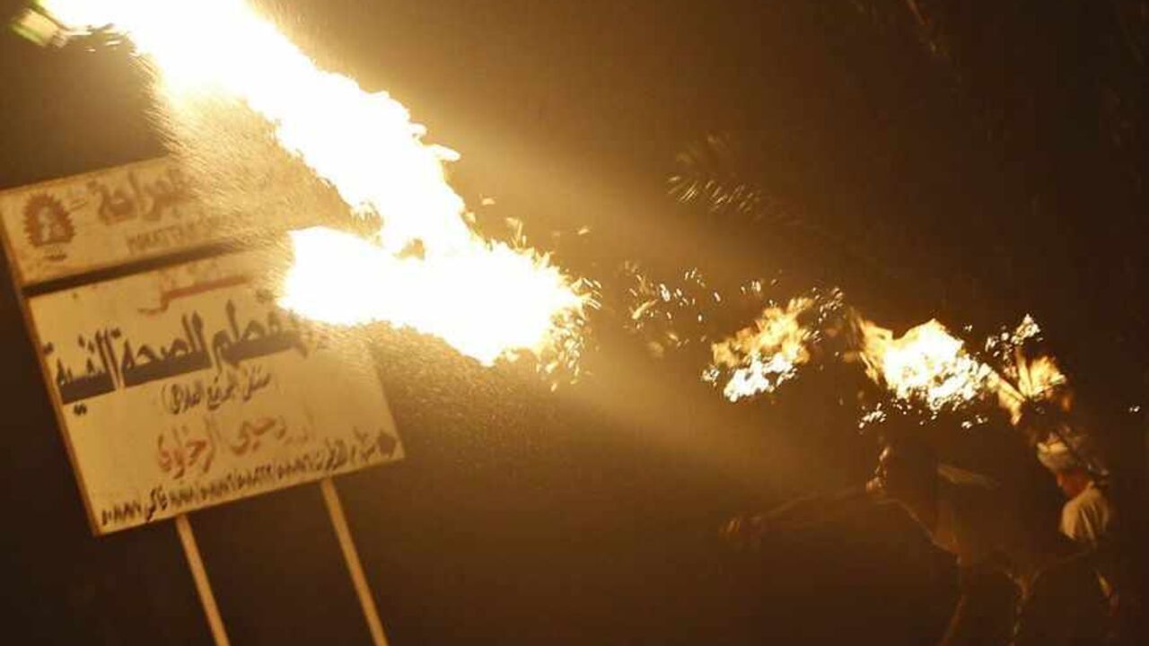 A protester opposing Egyptian President Mursi throws Molotov cocktails at the national headquarters of the Muslim Brotherhood in Cairo A protester opposing Egyptian President Mohamed Mursi throws Molotov cocktails at the national headquarters of the Muslim Brotherhood in Cairo's Moqattam district June 30, 2013. Millions of Egyptians flooded into the streets on the first anniversary of Islamist President Mursi's inauguration on Sunday to demand that he resign in the biggest challenge so far to rule by his Muslim Brotherhood. REUTERS/Amr Abdallah Dalsh (EGYPT - Tags: POLITICS CIVIL UNREST TPX IMAGES OF THE DAY) - RTX117RC
