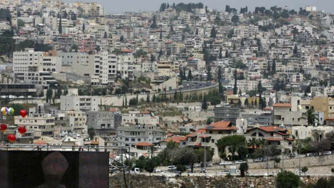 Pope Benedict XVI is seen on a large screen as he celebrates a mass on Mount Precipice in the northern Israeli city of Nazareth (seen in background) May 14, 2009. Pope Benedict, visiting the town of Jesus's boyhood, on Thursday addressed the largest crowd of his Middle East trip and said governments had a duty to defend traditional heterosexual marriage and family values. More than 40,000 people attended the outdoor mass -- celebrated in Arabic, English and Latin -- in the area of Nazareth known as Mount Pr