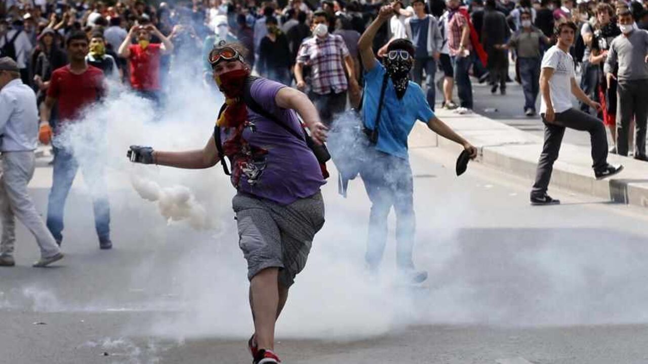TURKEY-PROTESTS/ A protester throws a gas canister back at the riot police during a demonstration in Ankara, June 3, 2013. Turkish Prime Minister Tayyip Erdogan accused anti-government protesters on Monday of walking "arm-in-arm with terrorism", remarks that could further inflame public anger after three days of some of the most violent riots in decades. Hundreds of police and protesters have been injured since Friday in the riots, which began with a demonstration to halt construction in a park in an Istanbul square and gre