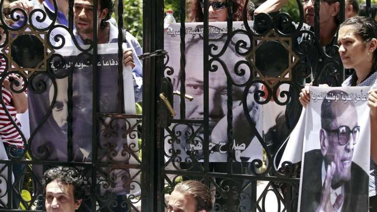 Intellectuals and artists, who are anti-Mursi protestors, carry pictures of some of the popular Egyptian artists and writers stand in front of the Ministry of Culture to demonstrate against what they claimed are increasing influence of the Muslim Brotherhood over the Ministry of Culture, in Cairo June 9, 2013. Egyptian President Mohamed Mursi increased the influence of his Muslim Brotherhood over government in a cabinet reshuffle in May that replaced two ministers involved in crucial talks with the IMF over