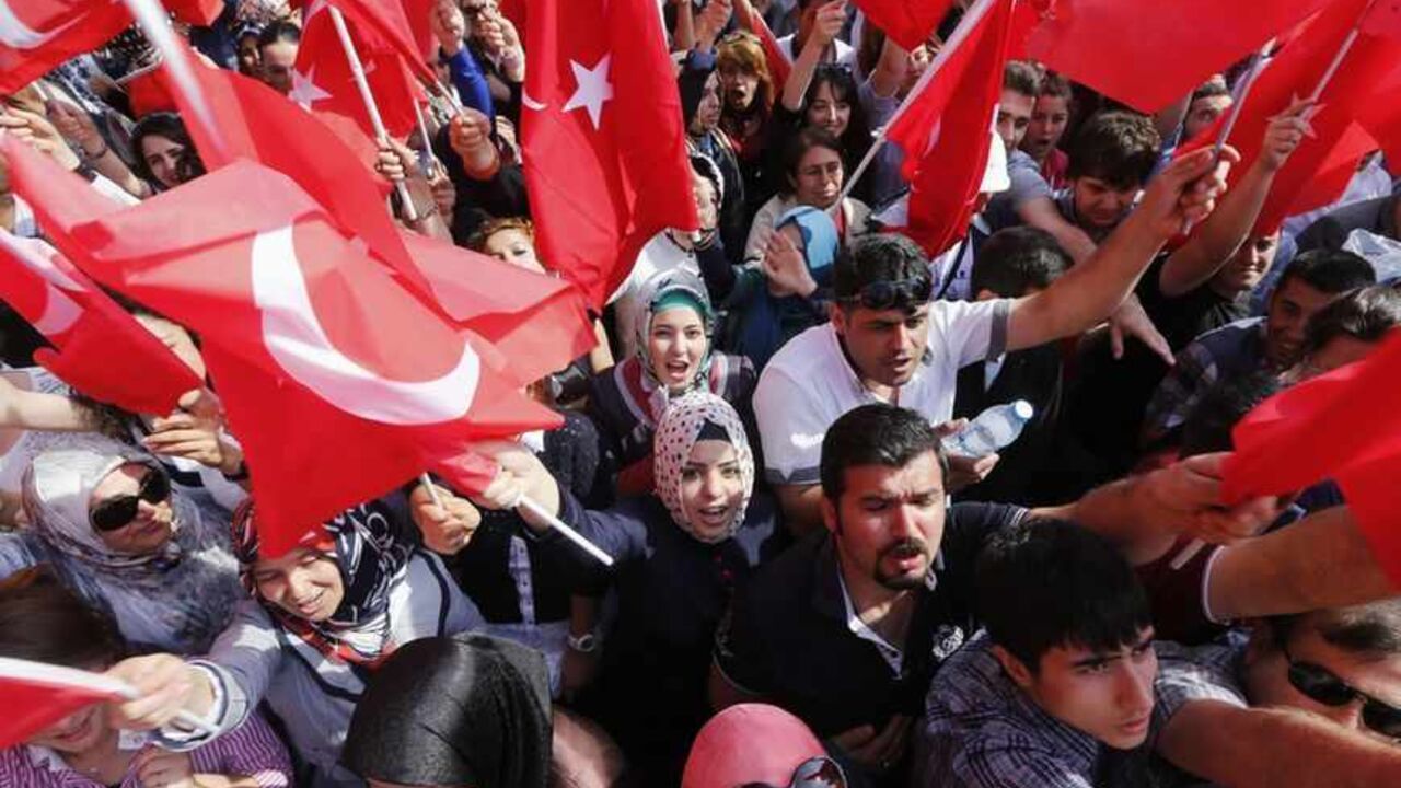 Supporters of Turkish PM Erdogan wait for his arrival at Esenboga Airport in Ankara Supporters of Turkey's Prime Minister Tayyip Erdogan wave flags, hold banners and shout slogans as they wait for his arrival at Esenboga Airport in Ankara June 9, 2013. Still by far the country's most popular politician, Erdogan has pressed ahead with government business as usual. REUTERS/Umit Bektas (TURKEY - Tags: POLITICS CIVIL UNREST TPX IMAGES OF THE DAY) - RTX10HBN