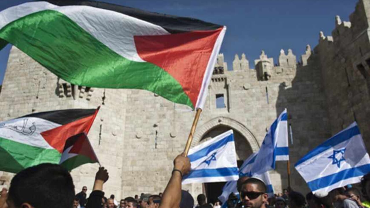 ISRAEL-PALESTINIANS/MUFTI Palestinian protesters wave Palestinian flags as Israelis carrying Israeli flags walk past in front of the Damascus Gate outside Jerusalem's Old City during a parade marking Jerusalem Day May 8, 2013. Jerusalem Day marks the anniversary of Israel's capture of the Eastern part of the city during the 1967 Middle East War. In 1980, Israel's parliament passed a law declaring united Jerusalem as the national capital, a move never recognised internationally. There were confrontations on Wednesday between Muslims