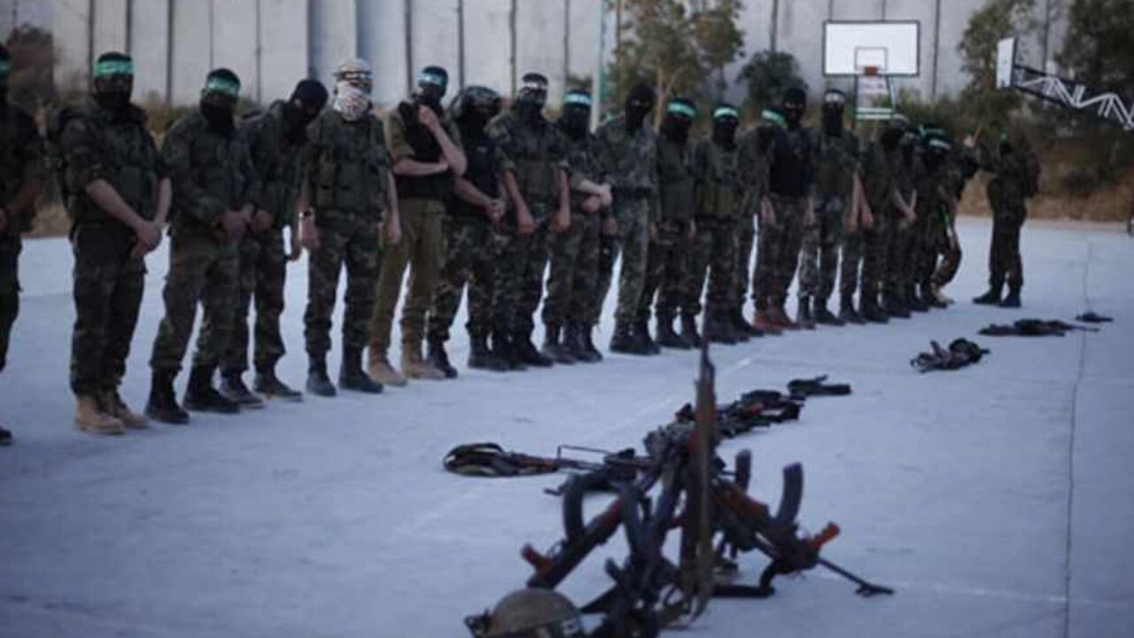 PALESTINIANS-ISRAEL/PRISONER Hamas militants stand for prayer before a protest in the northern Gaza Strip April 2, 2013. Israeli prison guards fired tear gas to quell disturbances by Palestinian inmates on Tuesday after a prisoner serving a life sentence over an attempt to bomb an Israeli cafe died of cancer. Maysara Abu Hamdeya's death threatened to raise tensions in the Israeli-occupied West Bank, where Palestinians, who view jailed brethren as heroes in a fight for statehood, have held several protests in recent weeks in support of