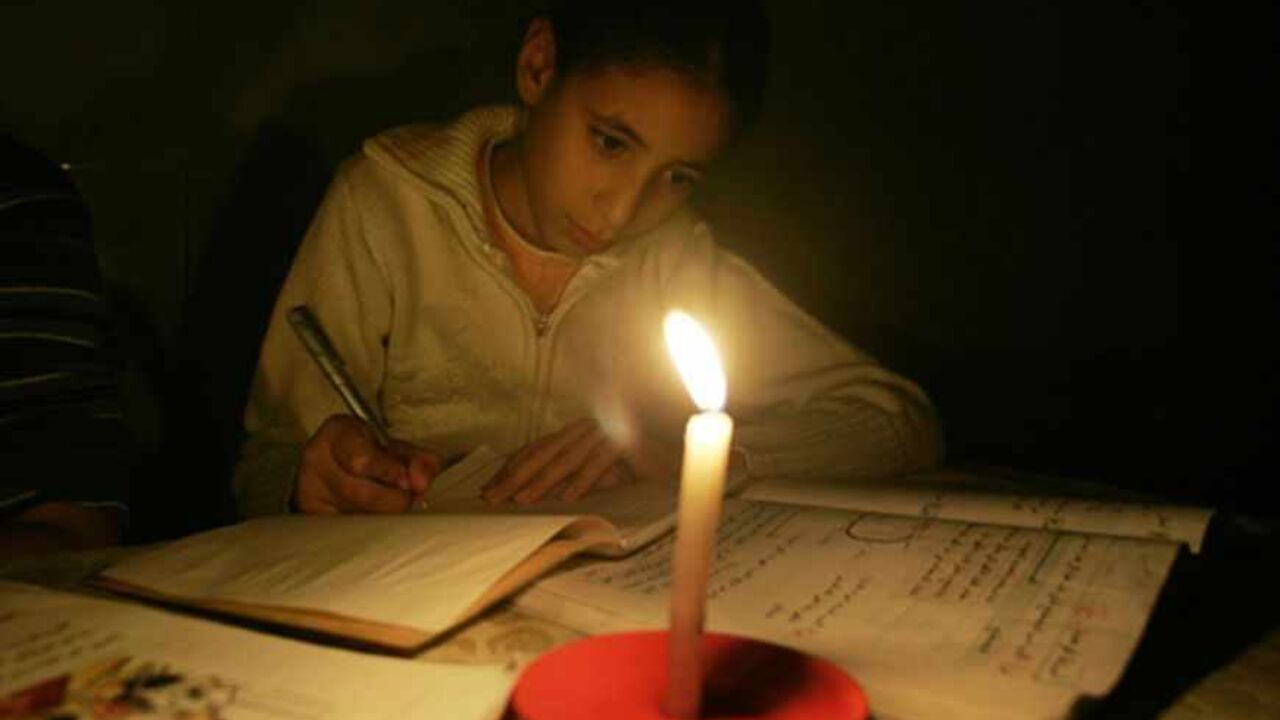 PALESTINIANS-ISRAEL/GAZA A Palestinian girl studies by candle light during a power cut in Gaza November 13, 2008 November 13, 2008. A United Nations aid agency said on Thursday it had run out of food supplies for 750,000 Palestinians in the Hamas-run Gaza Strip after Israel blocked deliveries by the world body.Short of fuel, Palestinian officials shut down Gaza's sole power plant as Israel kept commercial crossings with the coastal territory closed for a 10th day. REUTERS/Ismail Zaydah (GAZA) - RTXAK2X