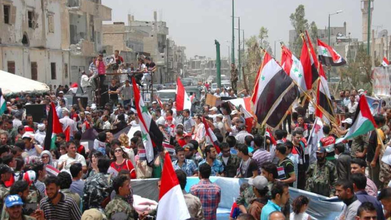 Lebanese and Syrian supporters of Syria's President Bashar al-Assad celebrate in Qusair June 9, 2013, after the Syrian army and Lebanese Hezbollah fighters took control of the town from rebel fighters in this handout photograph released by Syria's national news agency SANA. REUTERS/SANA/Handout via Reuters (SYRIA - Tags: POLITICS CIVIL UNREST) ATTENTION EDITORS - THIS IMAGE WAS PROVIDED BY A THIRD PARTY. FOR EDITORIAL USE ONLY. NOT FOR SALE FOR MARKETING OR ADVERTISING CAMPAIGNS. THIS PICTURE IS DISTRIBUTED