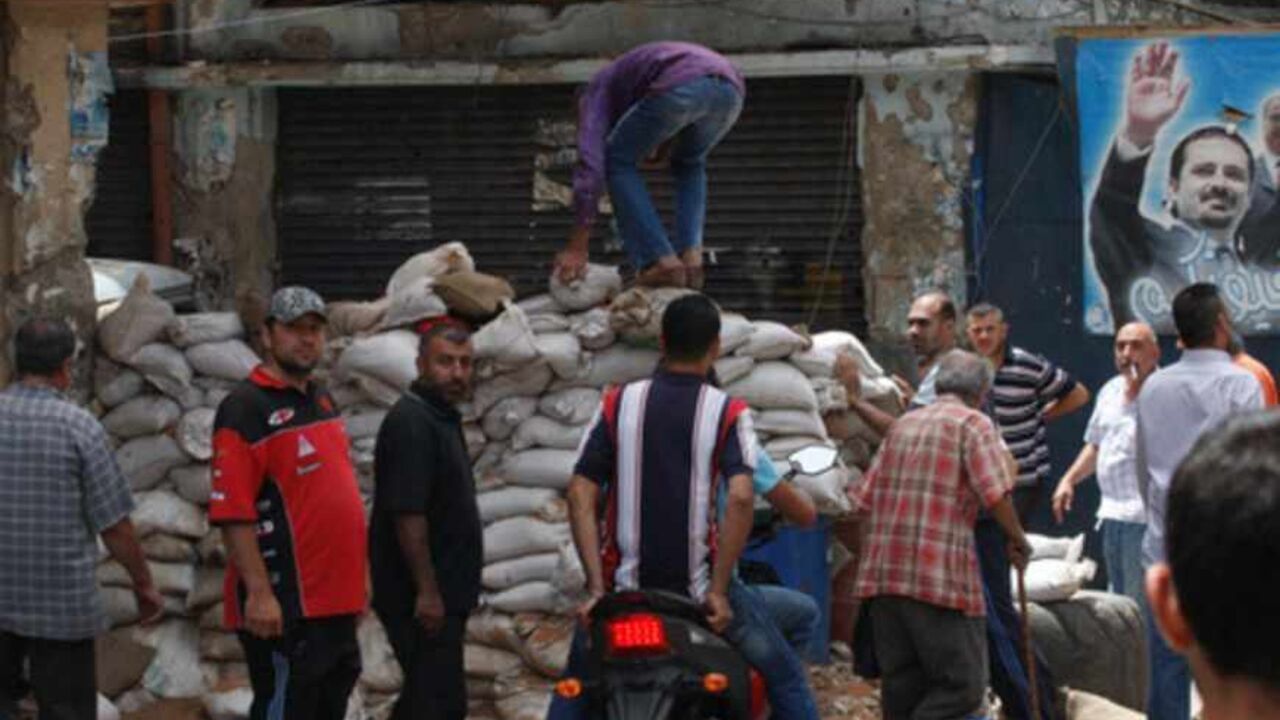 Lebanese residents remove barricades after months of clashes between Sunni Muslims and the small Alawite community, in Tripoli Lebanese residents remove barricades after months of clashes between Sunni Muslims and the small Alawite community, in Tripoli June 9, 2013. REUTERS/Stringer (LEBANON - Tags: POLITICS CIVIL UNREST) - RTX10HDG