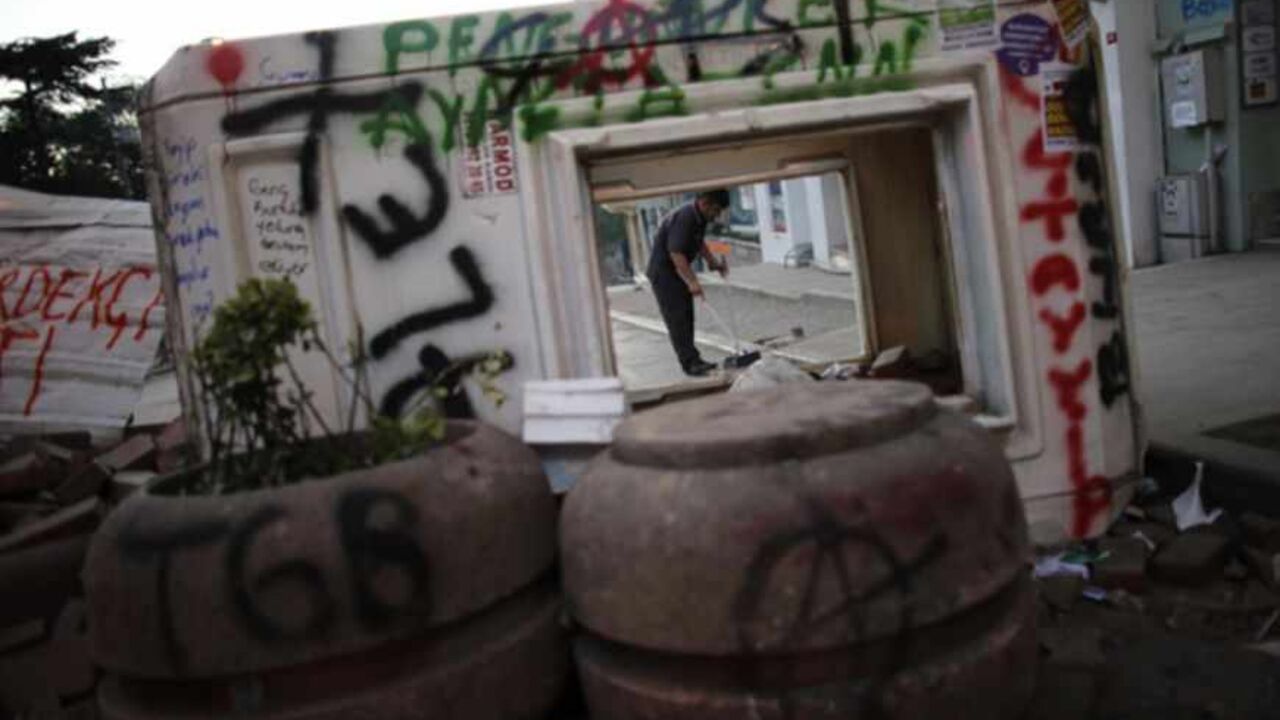 A hotel employee is pictured behind a barricade as he cleans the street near Taksim square in central Istanbul A hotel employee is pictured behind a barricade as he cleans the street near Taksim square in central Istanbul June 10, 2013. Turkey's Prime Minister Tayyip Erdogan warned protesters who have taken to the streets across Turkey demanding his resignation that his patience has its limits and compared the unrest with an army attempt six years ago to curb his power. REUTERS/Murad Sezer (TURKEY - Tags: POLITICS CIVIL UNREST) - RTX10I8R