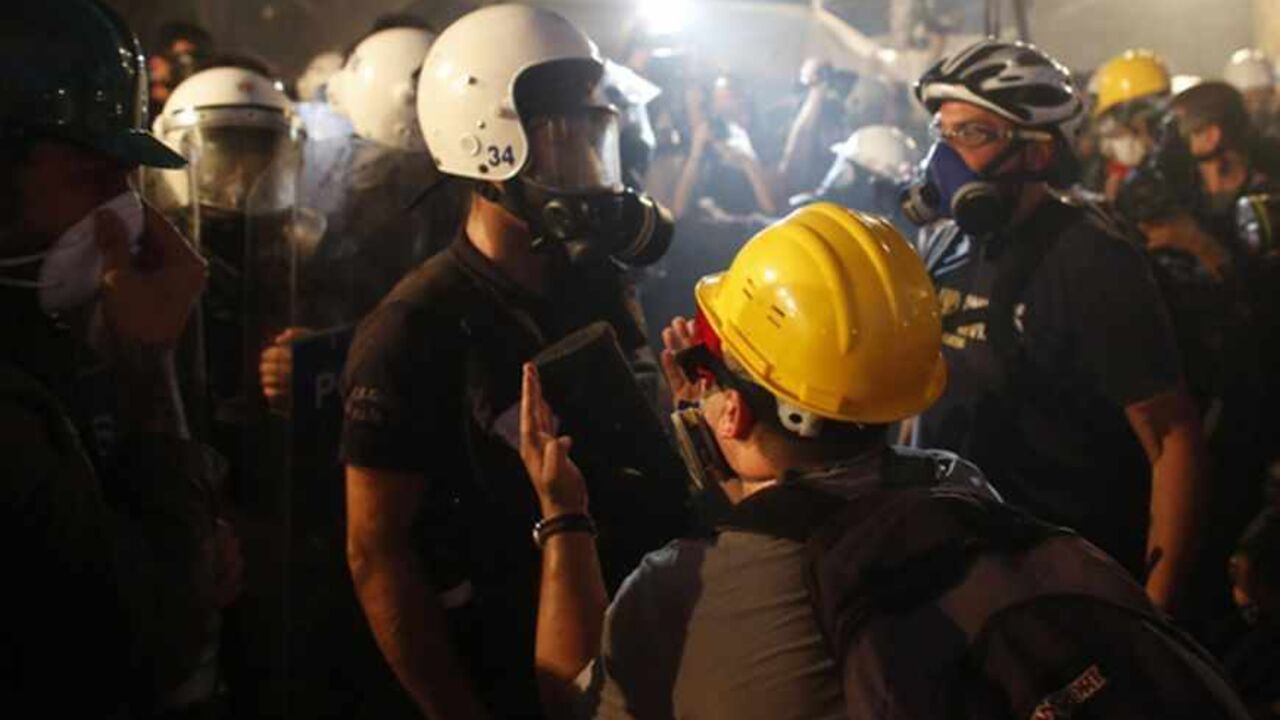 A protester reacts as riot police order them to evacuate Gezi Park in central Istanbul A protester reacts as riot police order them to evacuate Gezi Park in central Istanbul June 15, 2013. Thousands of people took to the streets of Istanbul overnight on Sunday, erecting barricades and starting bonfires, after riot police firing teargas and water cannon stormed a park at the centre of two weeks of anti-government unrest. Lines of police backed by armoured vehicles sealed off Taksim Square in the centre of the city as officers raided the adjoining Gezi Park late on Saturday, where protesters ha