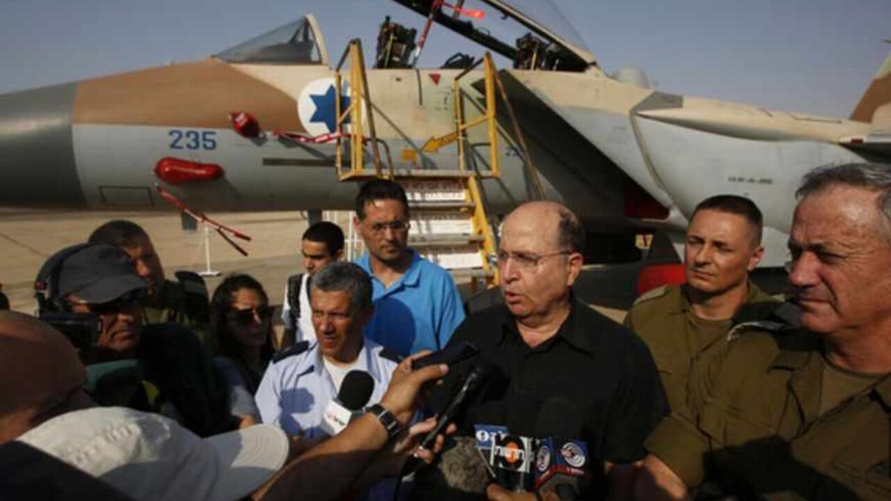 An Israeli Air Force F-15I jet is seen in the background as Israeli Defense Minister Yaalon speaks to reporters at an air base in southern Israel An Israeli Air Force F-15I jet is seen in the background as Israeli Defense Minister Moshe Yaalon (3rd R) speaks to reporters while standing next to Israel's armed forces chief Major-General Benny Gantz (R) and commander of Israel's Air Force Major-General Amir Eshel (4th R) during a presentation at Hatzerim air base in southern Israel April 30, 2013. Israel on Tuesday launched its first targeted attack on a militant in Gaza since a war in November, killing a Palestinian jihadist in an air strike that put f