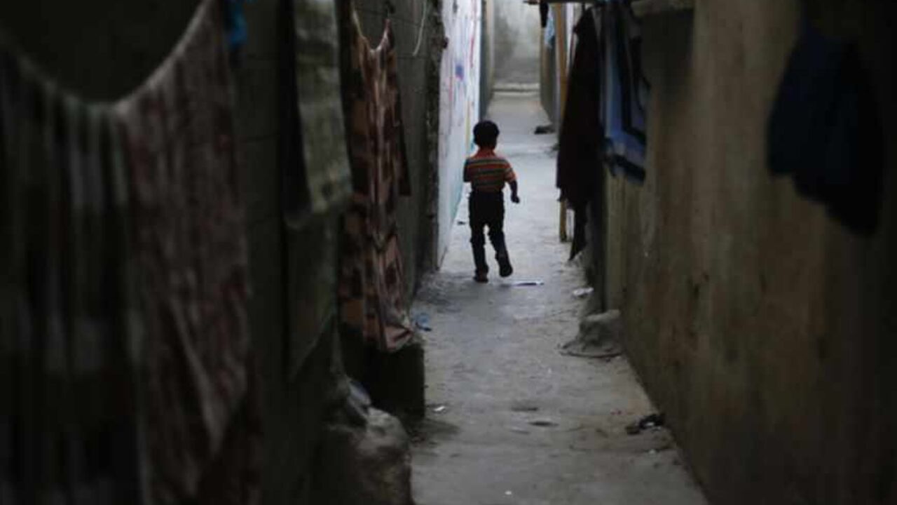 A Palestinian refugee boy walks between the narrow alleys of Jabalya refugee camp in the northern Gaza Strip A Palestinian refugee boy walks between the narrow alleys of Jabalya refugee camp in the northern Gaza Strip May 14, 2013. Palestinians will mark "Nakba" (Catastrophe) on May 15 to commemorate the expulsion or fleeing of some 700,000 Palestinians from their homes in the war that led to the founding of Israel in 1948. REUTERS/Suhaib Salem (GAZA - Tags: CIVIL UNREST POLITICS) - RTXZM8H