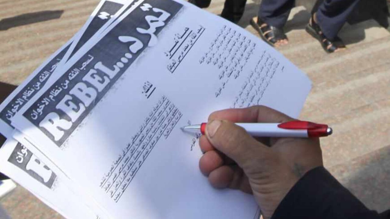A man signs a "Tamarod" document at Tahrir square in Cairo A man signs a "Tamarod" document at Tahrir square in Cairo May 16, 2013. A campaign named "Tamarod", meaning "Rebel", calling for the ouster of Egyptian President Mohamed Mursi and for early presidential elections has gathered over two million signatures since its launch nearly two weeks ago in Egypt, organisers said. REUTERS/Mohamed Abd El Ghany (EGYPT - Tags: POLITICS CIVIL UNREST) - RTXZP6G