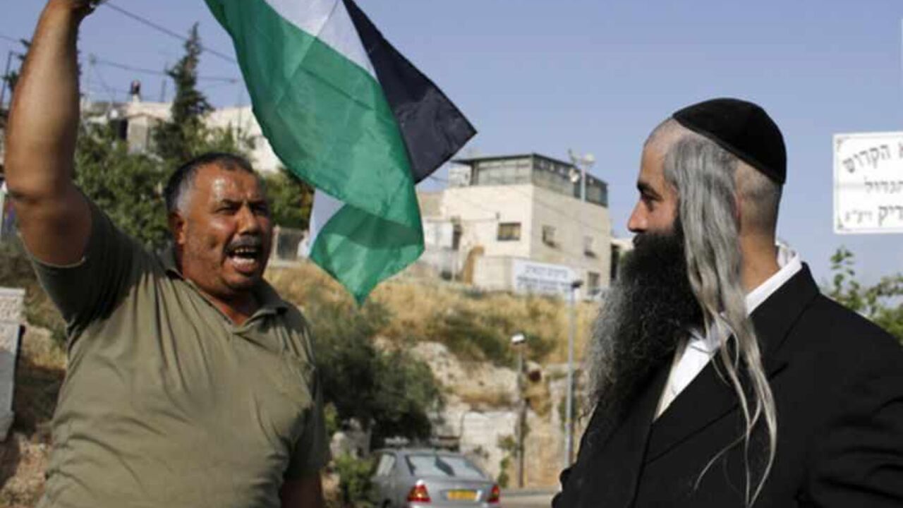 protester waving a Palestinian flag shouts at an Orthodox Jewish man in the Sheikh Jarrah neighborhood of East Jerusalem during a weekly demonstration against Jewish settlements A protester waving a Palestinian flag shouts at an Orthodox Jewish man in the Sheikh Jarrah neighborhood of East Jerusalem May 17, 2013, during a weekly demonstration against Jewish settlements and the possible eviction of a Palestinian family from their home. REUTERS/Ammar Awad (JERUSALEM - Tags: POLITICS CIVIL UNREST) - RTXZQQB