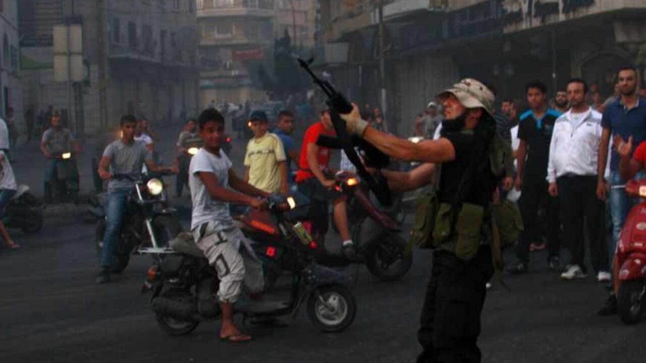 A Sunni Muslim gunman fires his weapon expressing his support with Salafist leader Ahmad al-Assir in Tripoli, northern Lebanon A Sunni Muslim gunman fires his weapon expressing his support with Salafist leader Ahmad al-Assir in Tripoli, northern Lebanon, June 23, 2013. At least three Lebanese soldiers were killed in the coastal city of Sidon on Sunday in clashes with followers of a Sunni Islamist cleric who is a fierce critic of Hezbollah's military intervention in neighbouring Syria, a security official said. Sources in the city said the fighting broke out when a follower of Sheikh Ahmed al-Assir was arrested at an army roadblock