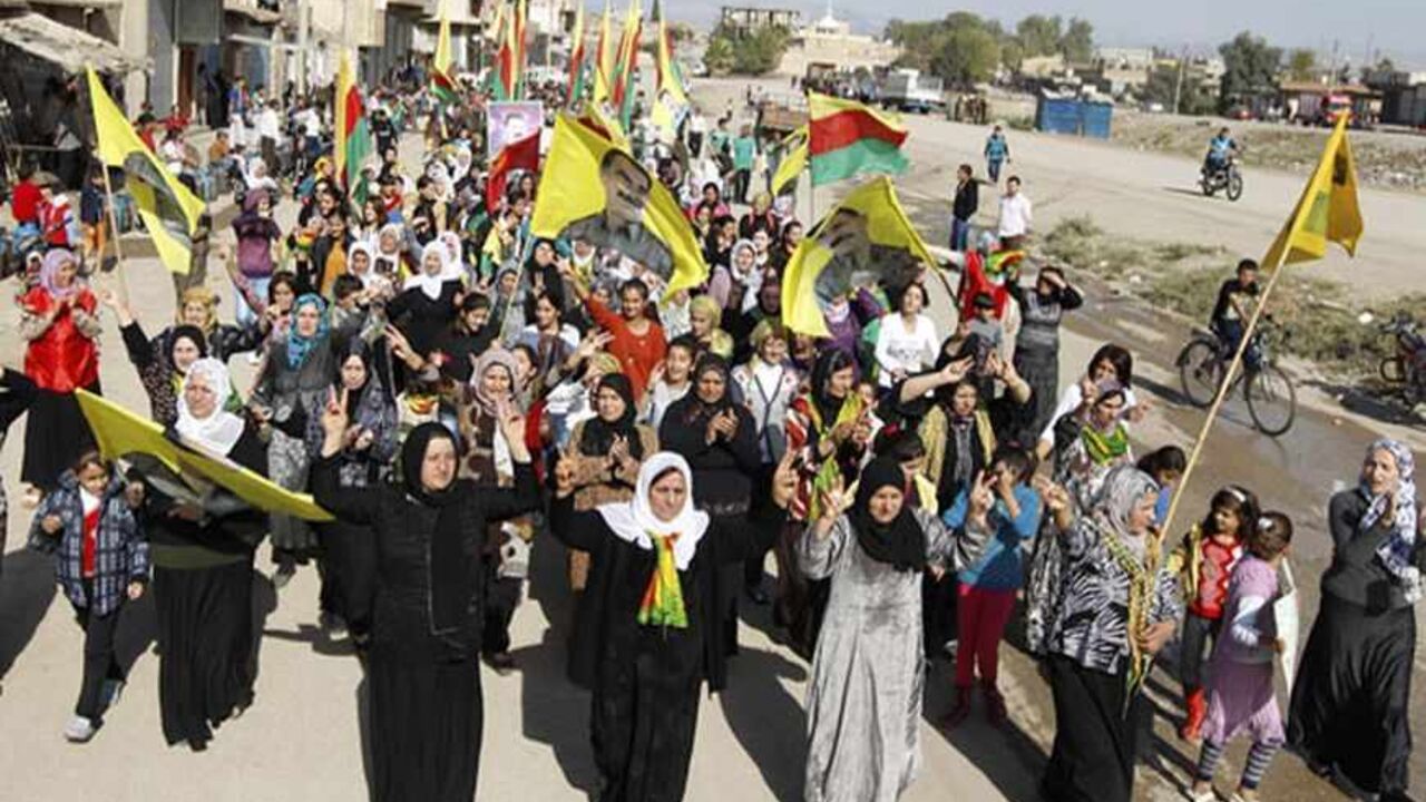 SYRIA-KURDS/PROTEST Syrian Kurds demonstrators hold flags and portraits of jailed Kurdistan Workers Party (PKK) leader Abdullah Ocalan during a protest in Derik, Hasakah November 1, 2012. Around 1,000 Syrian Kurds protested in the north-eastern Syrian town of Derik on Thursday, demanding the re-opening of Kurdish-language schools they said were closed by President's Bashar al-Assad's regime. REUTERS/Thaier al-Sudani (SYRIA - Tags: POLITICS CIVIL UNREST CONFLICT EDUCATION) - RTR39VNY