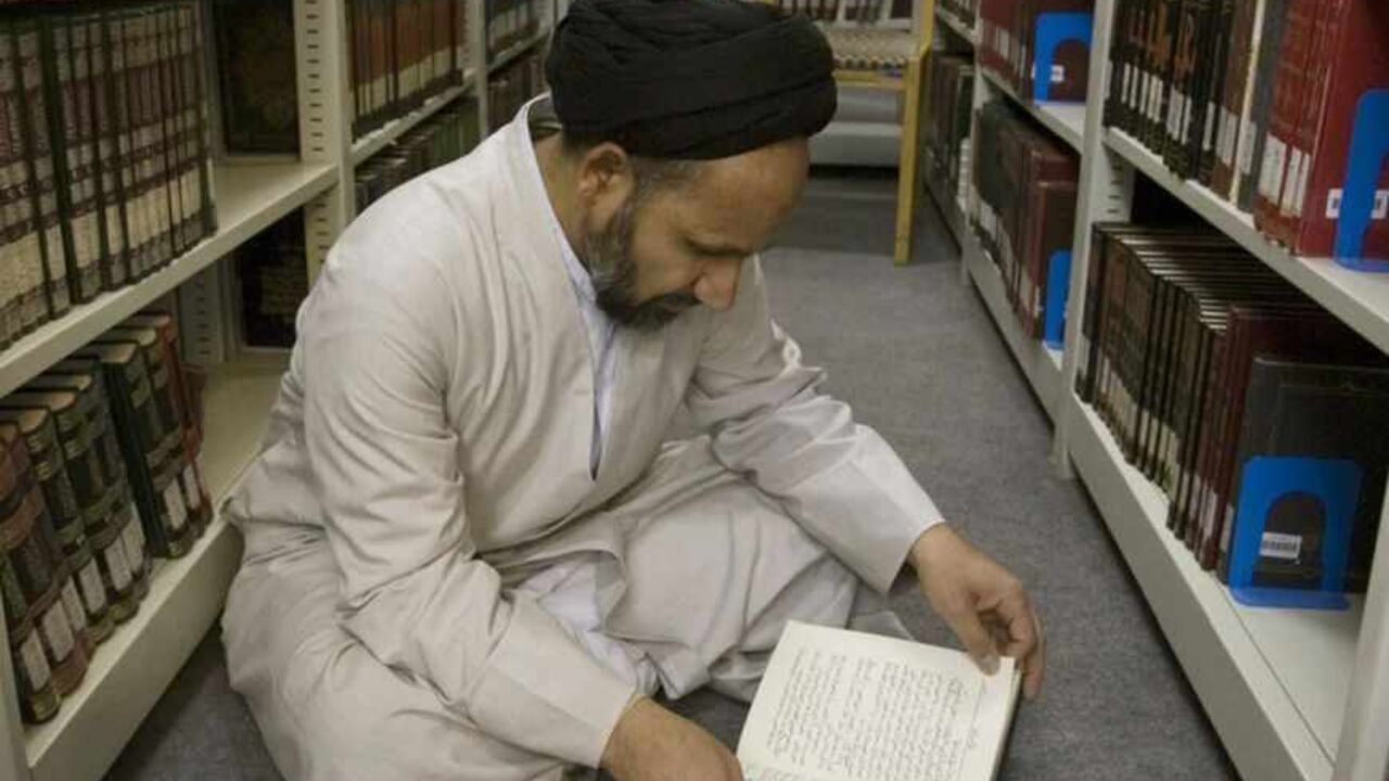 A cleric reads a book in the library of a religious research center associated with the seminary in Qom A cleric reads a book in the library of a religious research center associated with the seminary in Qom, 120 km (75 miles) south of Tehran February 2, 2009. REUTERS/Caren Firouz (IRAN) - RTXB5VE