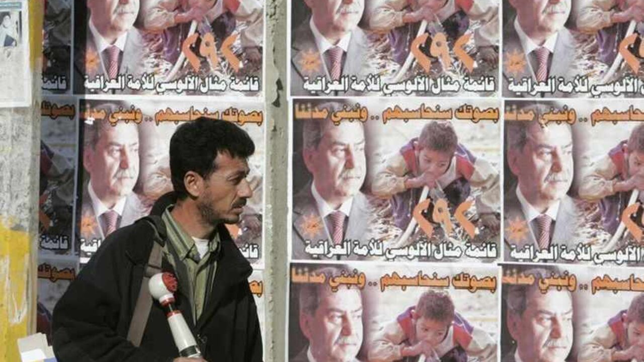 A resident walks past election campaign posters in Baghdad A resident walks past election campaign posters on Baghdad's Saadoun street January 3, 2009. The January 31 local election will apportion 440 seats on local councils that in turn name powerful regional governors. REUTERS/Saad Shalash (IRAQ) - RTR230LK
