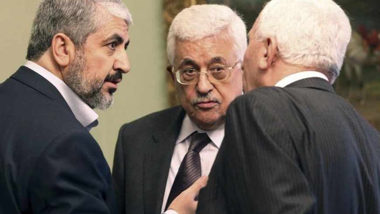 Hamas leader Khaled Meshaal and Palestinian President Mahmoud Abbas talk with an official during their meeting in Cairo Hamas leader Khaled Meshaal (L) and Palestinian President Mahmoud Abbas (C) talk with an official during their meeting in Cairo November 24, 2011. The leaders of Fatah and Hamas met for the first time in six months on Thursday and hailed progress toward ending Palestinian divisions that has led to separate governments in the West Bank and Gaza Strip, but there was no sign of a breakthrough. REUTERS/Mohamed Al Hams/Handout (EGYPT - Tags: POLITICS) FOR EDITORIAL USE ONLY. NOT FOR SALE FOR MARKETING OR ADVER