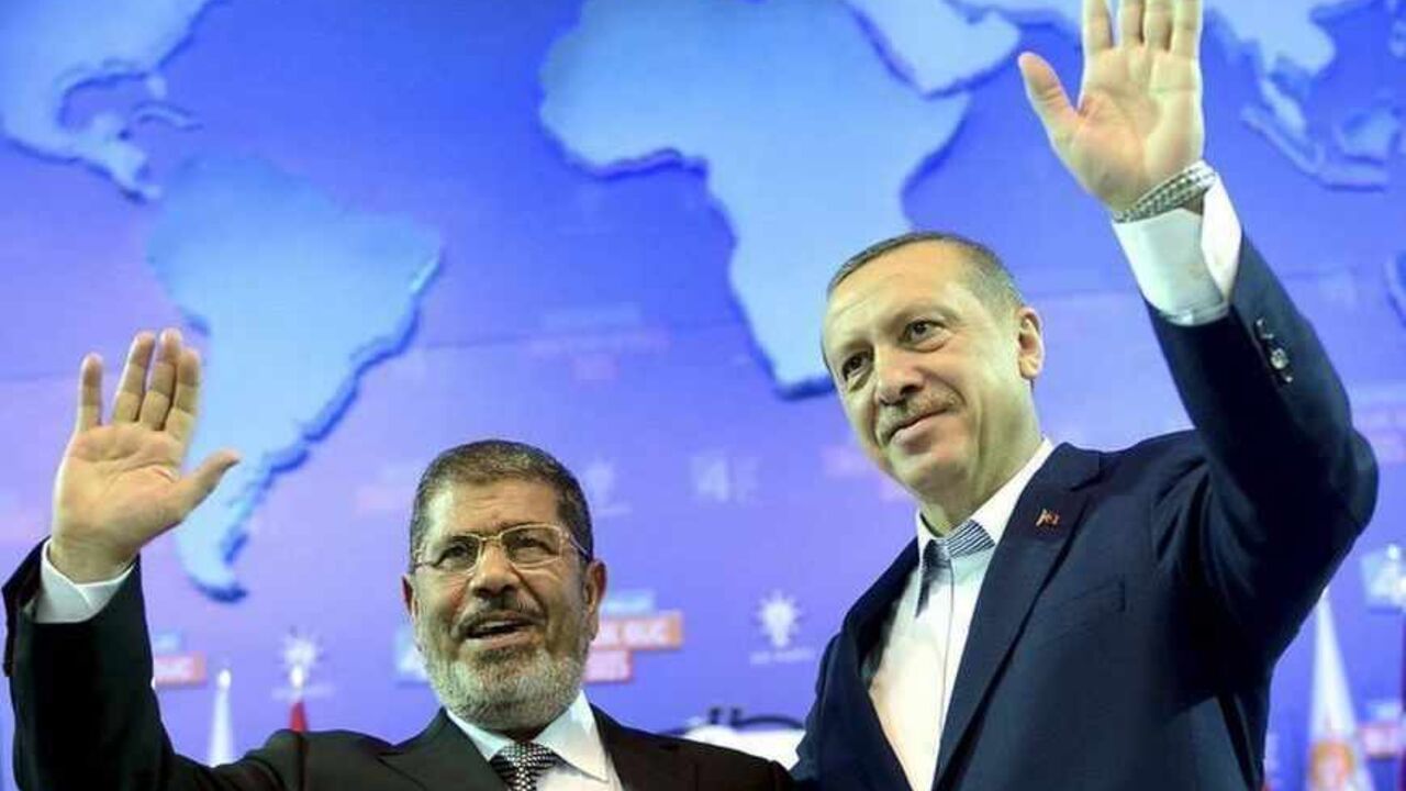 Turkey's PM and leader of ruling Justice and Development Party Erdogan and his guest Egypt's President Mursi greet the audience during AK Party congress in Ankara Turkey's Prime Minister and leader of ruling Justice and Development Party (AKP) Tayyip Erdogan (R) and his guest Egypt's President Mohamed Mursi greet the audience during AK Party congress in Ankara September 30, 2012. Erdogan trumpeted Turkey's credentials as a rising democratic power on Sunday, saying his Islamist-rooted ruling party had become an example to the Muslim world after a decade in charge. Addressing thousands of party members and regional leaders at a congress of his Justice and Development (