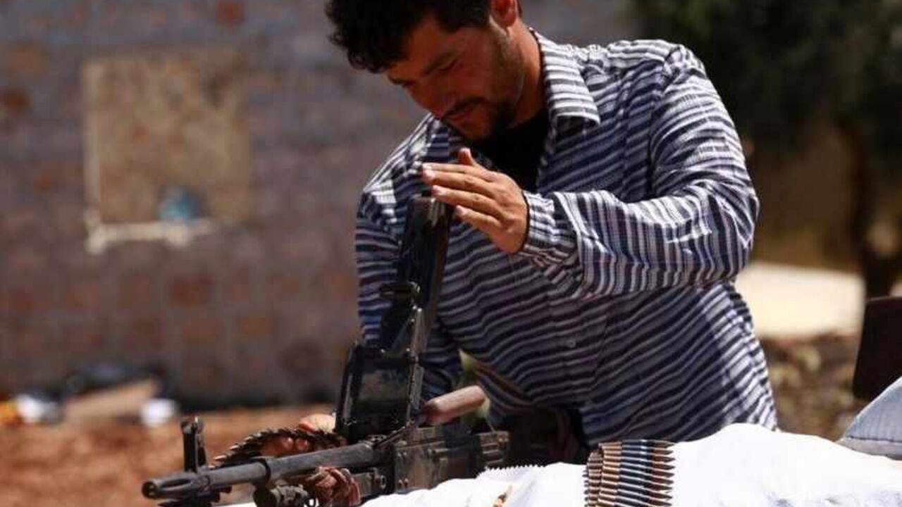A Free Syrian Army member inspects his weapon beside a checkpoint to siege the Kurdish city of Afrin, which is under the control of the Kurdistan Workers' Party (PKK), in the Aleppo countryside A Free Syrian Army member inspects his weapon beside a checkpoint to siege the Kurdish city of Afrin, which is under the control of the Kurdistan Workers' Party (PKK), in the Aleppo countryside June 30, 2013. REUTERS/Hamid Khatib (SYRIA - Tags: POLITICS CIVIL UNREST CONFLICT) - RTX117H8