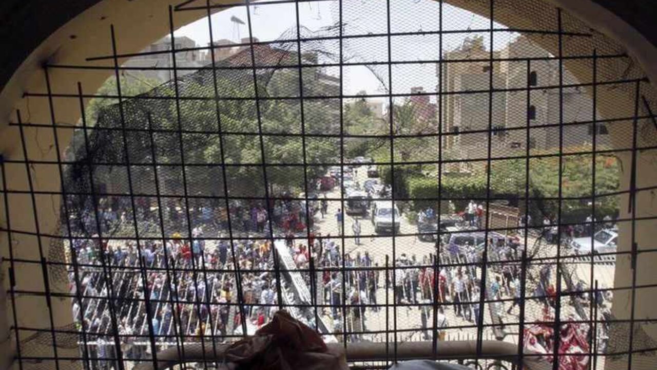 Protesters are seen through a damaged window from inside the Muslim Brotherhood's headquarters after it was attacked by protesters in Cairo Protesters are seen through a damaged window from inside the Muslim Brotherhood's headquarters after it was attacked by protesters opposing Egyptian President Mohamed Mursi in Cairo's Moqattam district July 1, 2013. The Brotherhood said on Monday that armed men who ransacked its national headquarters had crossed a red line of violence, and the movement was considering action to defend itself. Hundreds of people threw petrol bombs and rocks at the building, which caught fire as guards and Brotherhood members