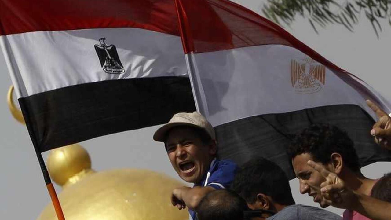 Members of the Muslim Brotherhood and supporters of deposed Egyptian President Mohamed Mursi shout slogans in front of army soldiers at Republican Guard headquarters in Nasr City Members of the Muslim Brotherhood and supporters of deposed Egyptian President Mohamed Mursi shout slogans in front of army soldiers at Republican Guard headquarters in Nasr City, a suburb of Cairo July 8, 2013. At least 51 people were killed on Monday when demonstrators enraged by the military overthrow of Egypt's elected Islamist president said the army opened fire during morning prayers outside the Cairo barracks where Mursi is believed to be held. REUTERS/Amr Abdallah Dalsh (EGYPT - Tags: POLITICS CIVI