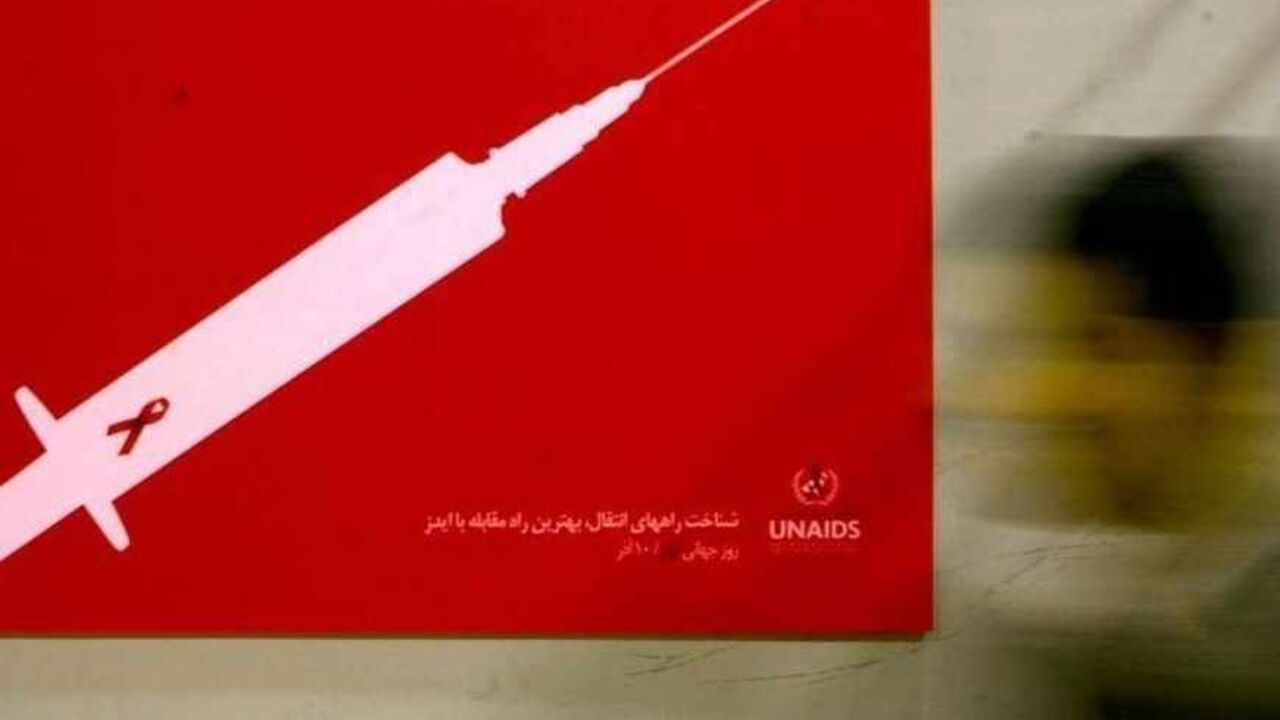 A man walks past a poster at a conceptual art exhibition about HIV/AIDS in Tehran A man walks past a poster at a conceptual art exhibition about HIV/AIDS in Tehran December 2, 2007. REUTERS/Morteza Nikoubazl (IRAN) - RTX4B45