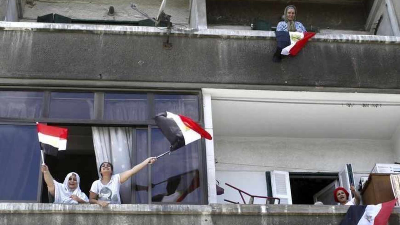 Women chant slogans from their windows to show their support for an anti-Mursi protest in Alexandria Women chant slogans from their windows to show their support for an anti-Mursi protest by police officers and protesters after the funeral of Brigadier General Mohamed Hani, a senior police officer from Alexandria, in the streets of Alexandria July 1, 2013. Mohamed Hani was shot dead by unknown gunmen who ambushed his car in the Sinai Peninsula town of El Arish on Saturday, security sources and state media said. REUTERS/Asmaa Waguih (EGYPT - Tags: POLITICS CIVIL UNREST) - RTX118S7